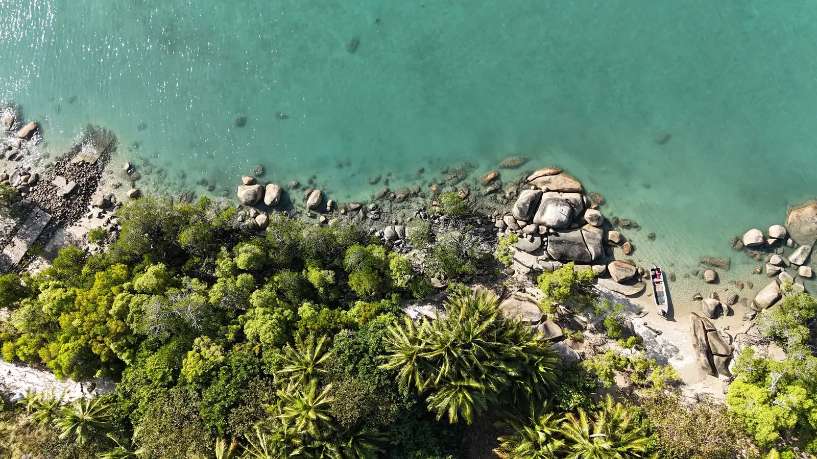 Aerial view of a rocky, forested coastline in the Torres Strait